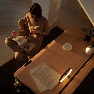 a woman sitting in her beflo workspace with Tenon smart desk
