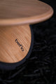 Wooden footrest with 'beflo' branding on a black textured surface