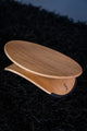 Wooden footrest balance board on a dark textured surface